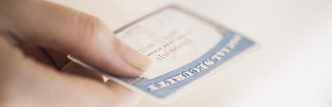 Close up of woman's hand holding social security card